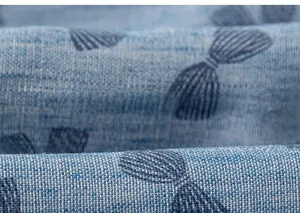 Detail of blue woven fabric with bow patterns and cotton linen texture on kids dress