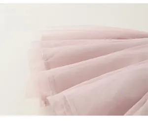 Detailed macro shot of layered soft pink mesh tutu skirt fabric for girls dress