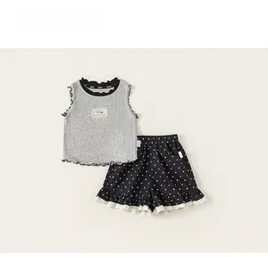 Close-up of girl's sleeveless ribbed top and heart print shorts with lace ruffles