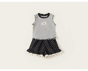 Detail of girls' ribbed tank top with ruffle trim and heart polka dot shorts with lace edges