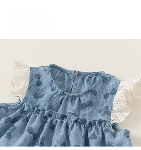 Detail of blue bow print dress featuring white embroidery lace sleeves and back button