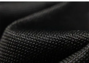 Macro detail of breathable black knitted mesh fabric showing honeycomb texture for comfort