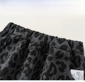 Detail shot of leopard print pants featuring elastic waistband and fabric wash label
