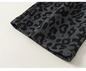 Close-up of leopard print kids pants showing the high-quality wide leg hem detail