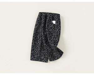 Detailed view of kids leopard print trousers with elastic waistband and wide-leg cut