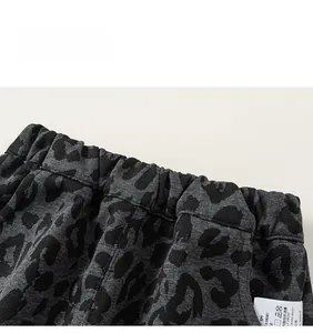 Detail view of children's leopard print casual pants with an elastic waist design