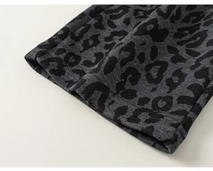 Detail view of leopard print cuff featuring grey knit fabric and durable double-stitch seams