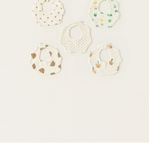 Detailed view of 5-piece set cotton petal bibs featuring animal and heart prints