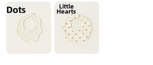 Detail view of cotton gauze petal bibs featuring brown heart and dark polka dot prints
