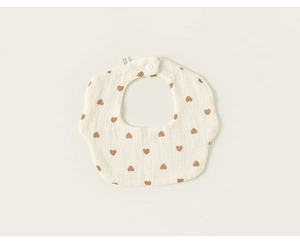Detail of soft cotton baby bib with brown heart print and secure snap button closure
