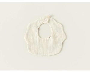 Close-up of petal-shaped cotton baby bib with gauze texture and snap buttons
