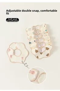 Detail of baby petal bib showing cartoon prints and adjustable snap buttons for secure fit
