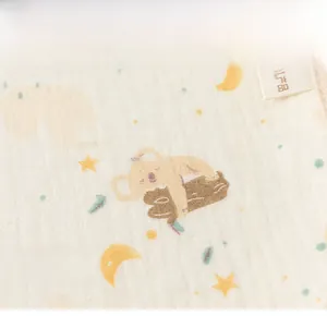 Close-up of breathable cotton gauze fabric with cute koala and star prints