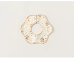 Detail of petal-shaped cotton bib with koala print and secure snap buttons