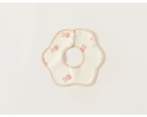 Close-up of 360-degree petal shaped baby bib with cute pink cartoon rabbit patterns