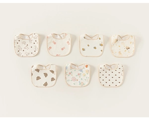 Flat lay of seven assorted soft cotton gauze baby bibs with cartoon animal prints