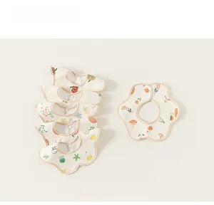 Detail view of 6-piece baby cotton bibs set with colorful patterns and snap buttons