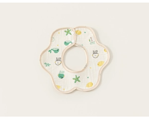 Detail of petal-shaped baby bib featuring ocean animal prints and a secure snap fastener
