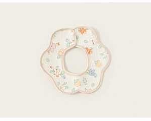 Detailed macro view of floral print cotton baby bib with adjustable white resin snap buttons
