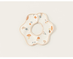 Detail of mushroom pattern on organic cotton petal bib with secure snap closure