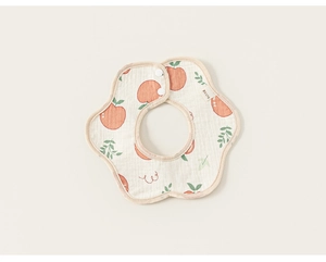 Detail of petal-shaped cotton gauze baby bib with orange fruit print and snap buttons
