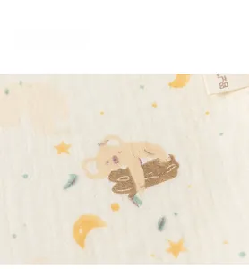 Detail shot of soft cotton gauze baby bib featuring cute cartoon koala and moon patterns