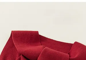 Close-up of red ribbed knit fabric texture showing premium soft cotton material details