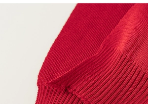 Close-up of vintage red knit shawl featuring premium vertical ribbed texture and soft fabric