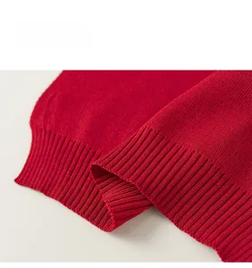 Close-up detail of the vibrant red ribbed knit cuff on this vintage children sweater