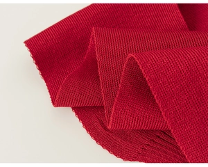 Macro shot of vibrant red ribbed knit fabric detail showing texture and elasticity
