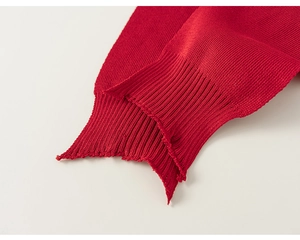 Detailed macro view of the premium red knitted shawl showing fine ribbed cuff texture