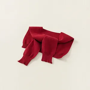 Classic deep red knit shawl for children with vertical ribbed texture on beige background