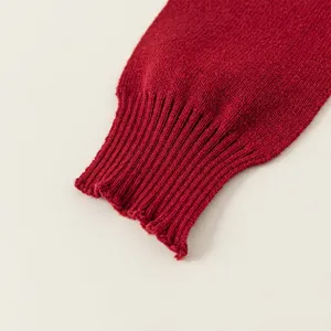 Classic red ribbed cuff of a children's knit sweater made from premium soft wool fabric