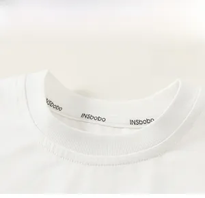 Detail of white cotton T-shirt ribbed crew neck with high-quality interior neck tape