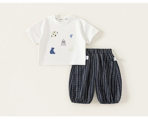 Detailed view of kids' cotton set featuring cute cartoon embroidery and striped pants