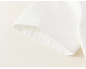 Close-up of double-needle stitching on white cotton short sleeve cuff of kids outfit