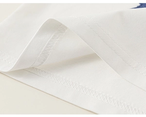 Detail of high-quality white cotton fabric showing precision double-thread stitching
