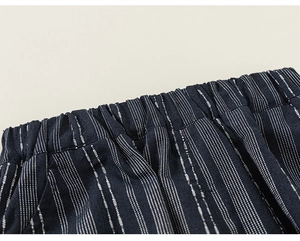 Close-up of elastic waistband on dark blue striped cotton-linen kids' shorts