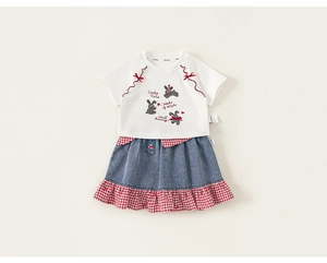 Detail of girls' white T-shirt with rabbit prints and denim skirt with gingham ruffles