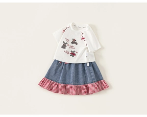 Detail of girls' white rabbit tee and denim skirt with red gingham patchwork hem