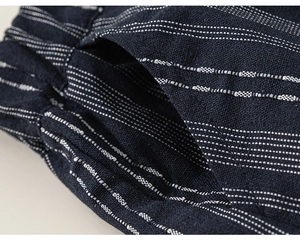 Macro shot of navy blue striped cotton-linen fabric with elastic waistband and side pocket