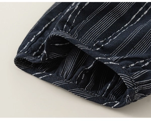 Close-up of navy striped sleeve with pleated cuff detail on kids cotton-linen outfit