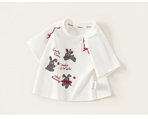 Close-up of white cotton T-shirt featuring cartoon rabbits and red ribbon bow details