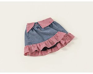 Detail view of denim skirt with red gingham ruffle hem and cute cherry applique