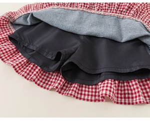 Detail view of red gingham skirt showing the built-in black safety shorts lining
