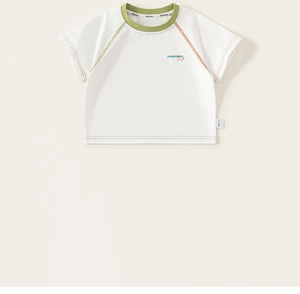 Detail of children's white T-shirt featuring rainbow contrast stitching and a dog print