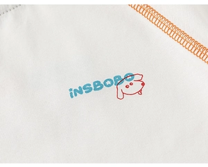 Close-up of white knit fabric with INSBOBO print, cartoon dog, and orange contrast stitching