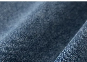 Macro shot of durable deep blue denim fabric texture and fine twill weaving detail