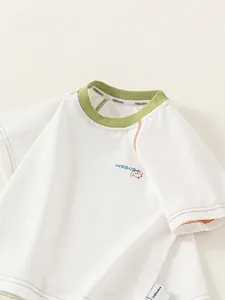 Kids' short-sleeved white t-shirt with green collar and cartoon dog print graphic