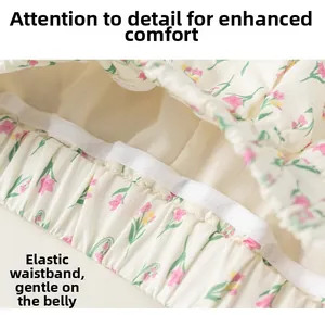 Gros plan détaillé de la taille élastique de la jupe à fleurs pour fille en beige et vert